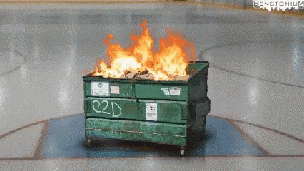 A dumpster on fire in the middle of a basketball court