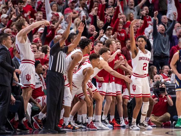Indiana guard Armaan Franklin (2) reacts with his teammates on the bench after hitting the game-winning three-point shot during the second half of game one against Notre Dame of the 2019 Crossroads Classic, Saturday, Dec. 21, 2019, at Bankers Life Fieldhouse. Indiana won 62-60.